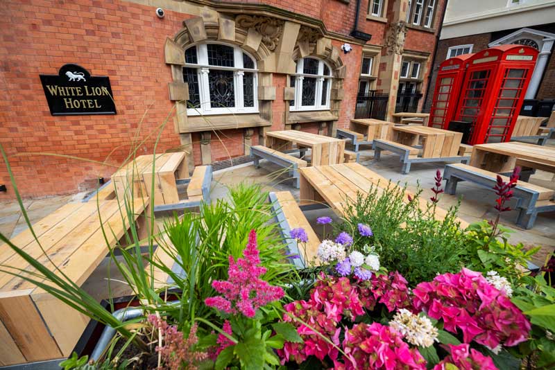 A building with benches and flowers