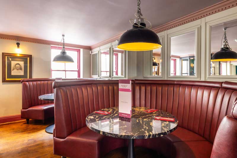 Alfredos commercial fit-out specialists in manchester red leather chairs in booth