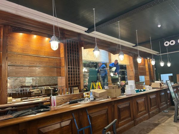 classic-building-group-bar-are-freemount The team fitting mirrored shelving and lighting in newly created and fitted timber bar interior during restaurant fit-out