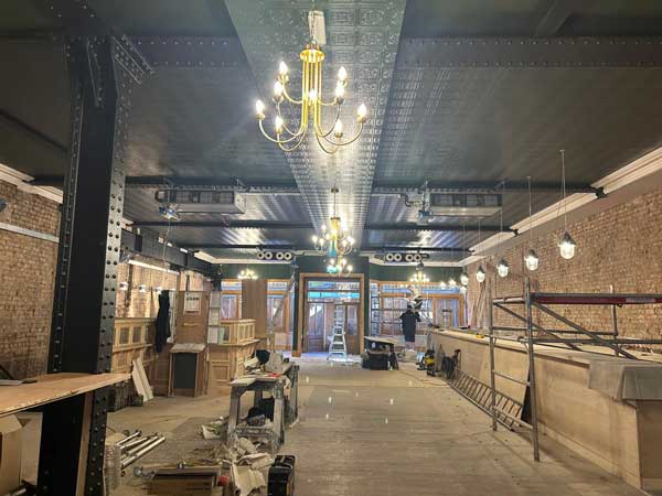 classic-building-group-freemount-northwest Professionally fitted chandeliers and lighting in a bar interior during restaurant fit-out