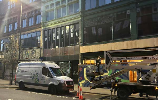 Working at height. A daylight image of the exterior of the freemount on manchester's oldham street, there is a classic building group van and elevation platform outside